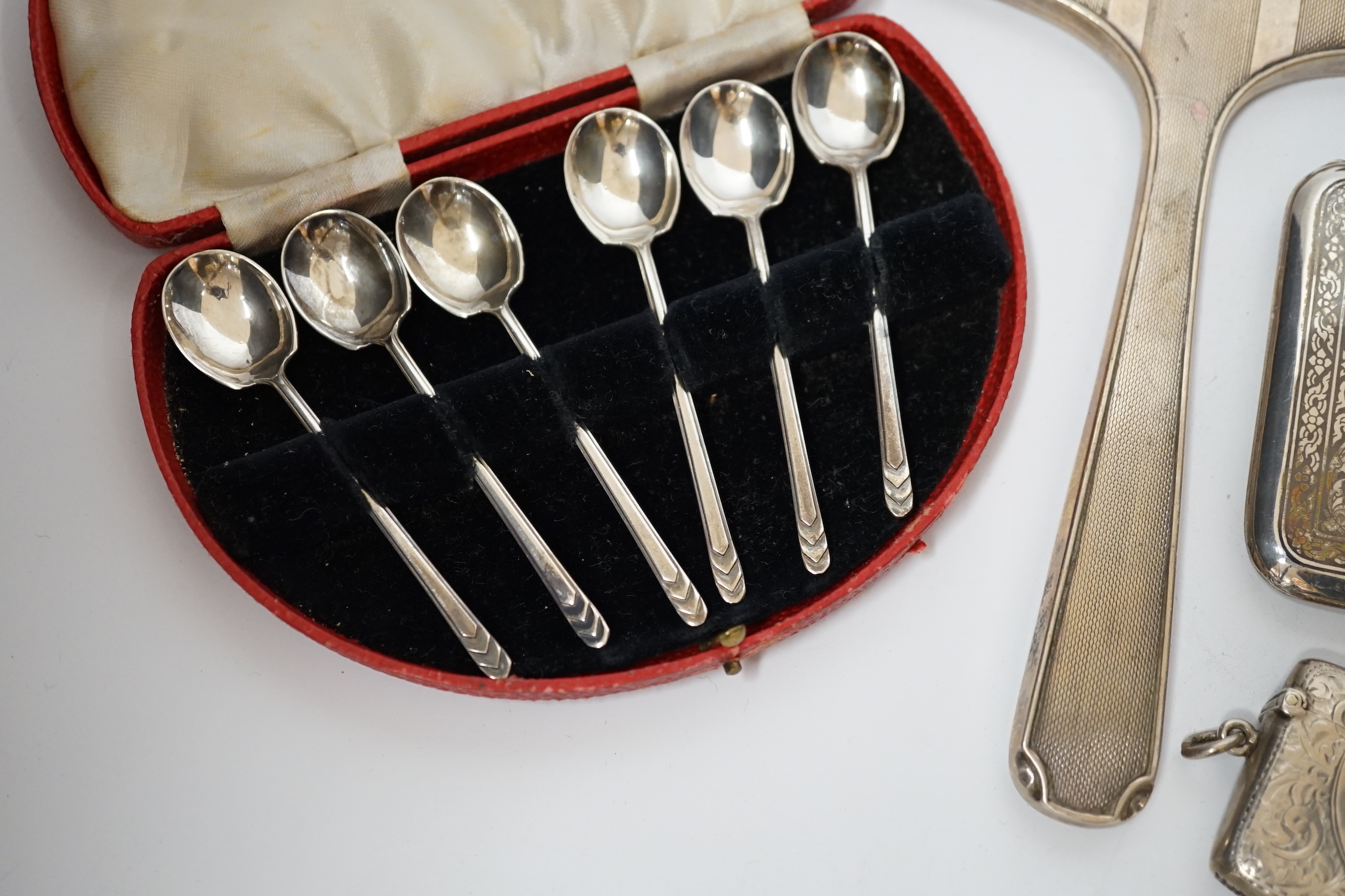 A quantity of assorted silver and sterling items including cigarette case, card case, vesta cases, mounted inkwell, glass handled salad server, plated vesta case, etc.